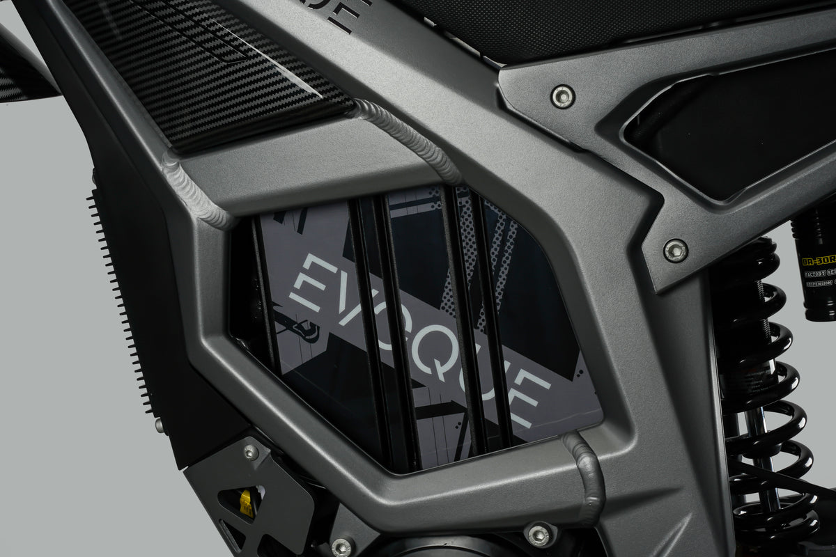 Close-up of a motorcycle's front suspension system with 'EXPLORER' branding. Evoque Raider Electric Dirt Bikes Front light